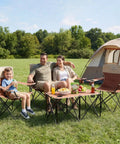 Family seated outdoors on Heavy Duty Camping Chair Set Of Four With Table For Adults Outdoor Folding Lawn Chairs Includes One Sofa Chair And Two Single Chairs Portable Collapsible Outdoor Furniture For Travel Picnics And Sports.