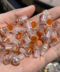 50 Pack UY2 K2 Gel Filled Waterproof IDC Wire Splice Connectors in hand, transparent design with orange cap, for 26-29 AWG wires.
