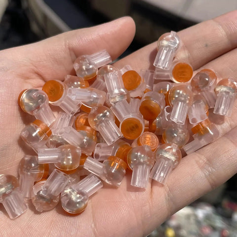 50 Pack UY2 K2 Gel Filled Waterproof IDC Wire Splice Connectors in hand, transparent design with orange cap, for 26-29 AWG wires.