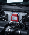 Two Piece Auto Fire Extinguisher Stickers With Heat Sensitive Aerosol Tech That Kick In Under The Hood For Smooth Engine Bay Protection And Reliable Passive Emergency Safety Gear No Power Needed mounted under car hood.