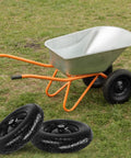 Wheelbarrow on grass with two 14.5 Inch Flat Free Solid Tire And Wheel For Yard Cart Garden Wagon With Three Quarter And Five Eighths Bearing