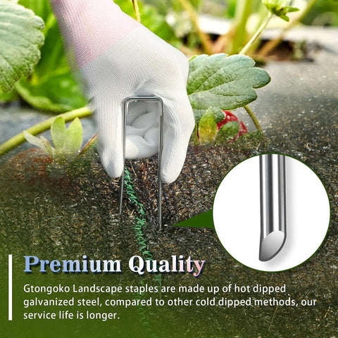 Hand placing 50 Pack 4-Inch Galvanized U Shaped Landscape Staples Garden Stakes For Lawn Landscaping Ground Stakes Weed Barrier Fabric Tent Stakes Outdoor Decor And Christmas Display 11 Gauge Rust Resistant Steel in soil