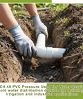 Person installing 2 Inch PVC Pipes Set Of 6 White Sch40 Industrial PVC Tubes 16.7 Inches Long in trench for outdoor use.
