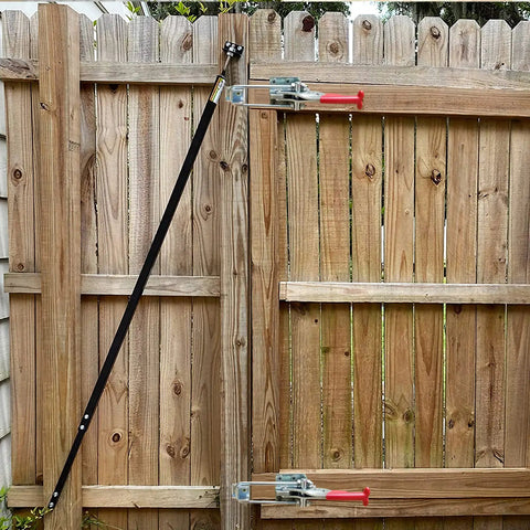 Wooden gate with Beefy 2000lbs Toggle Clamp Kit With Cam Latch Action, showing two metal clamps securely fastened.