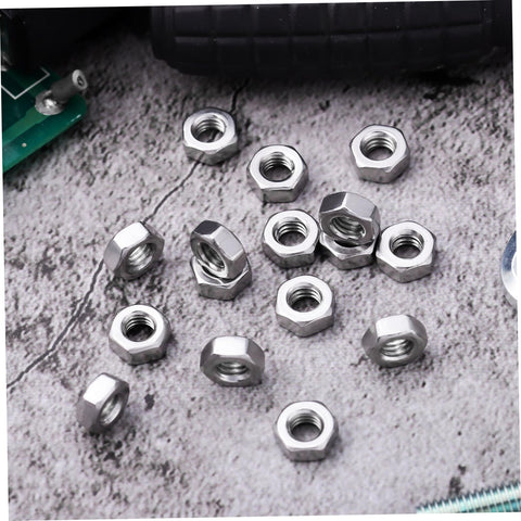 Heavy Duty Stainless Steel Hex Nuts Rock Solid Hardware Fasteners For Home Repairs And Industrial Projects Polished Steel Parts on gray surface.