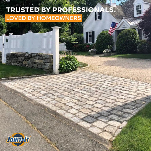 A paved driveway using Easy No Fuss Polymeric Sand Alternative For Joint Filling In Patios And Walkways, featuring cobblestones.