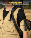 Person wearing tan vest with Two Point Shotgun Sling With 6 Shell Holders For 20 Gauge, showing non-slip shoulder pad and strap detail.