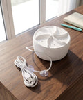 Portable Ultrasonic Washing Machine For Delicates And Underwear A Compact Space Saver For Dorms And Rvs on a wooden table with USB cable.