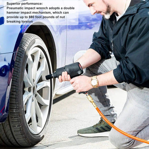Pneumatic Air Impact Wrench With Half Inch Drive Dropping 720 Nm Of Kickass Torque At 7800 Rpm being used by a mechanic on a car tire.