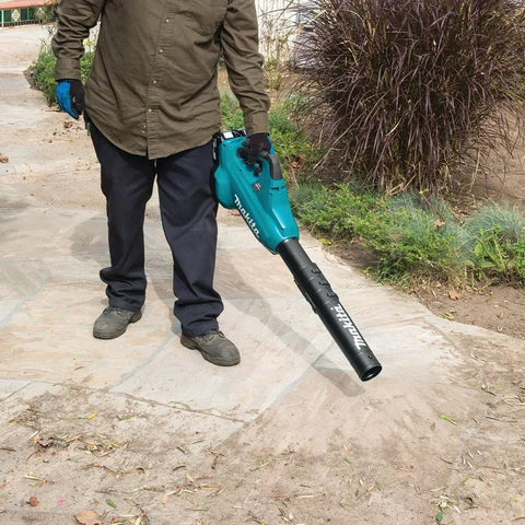 User operating No Nonsense 36V Brushless Cordless Leaf Blower With Beast Mode Airflow And Smooth Handling For Yard Cleanup Certified Refurbished Tool Only Built Tough Ready To Work on a stone path.