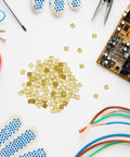 150 pieces gold plated copper solder chips for jewelry making and electronics repair with tools and circuit board nearby