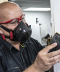 Person wearing Dust Mask With Replaceable Twin HEPA Filters For Woodworking And Construction, Half Face Pro Grade Mask