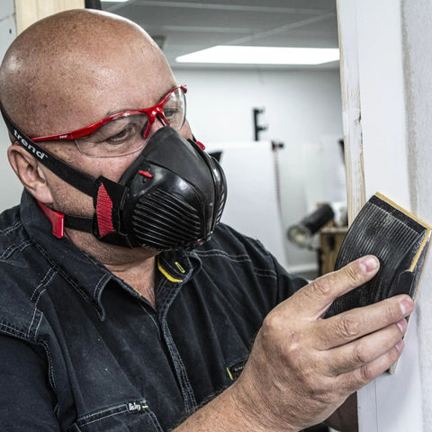 Person wearing Dust Mask With Replaceable Twin HEPA Filters For Woodworking And Construction, Half Face Pro Grade Mask