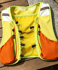 Trail Ready Hydration Running Vest With Lightweight Pack, yellow and orange mesh, for outdoor training on wooden table