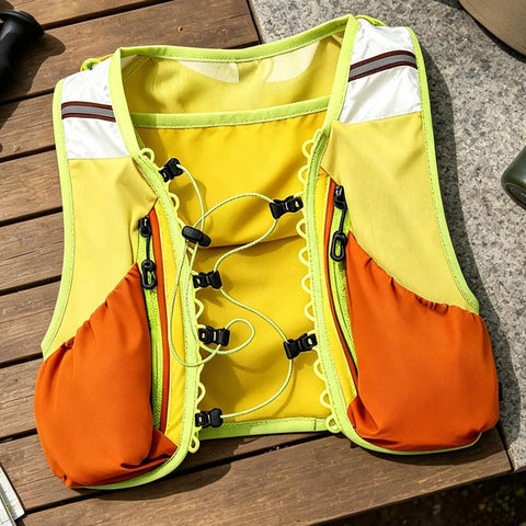 Trail Ready Hydration Running Vest With Lightweight Pack, yellow and orange mesh, for outdoor training on wooden table