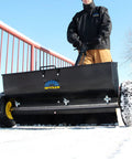 Spyker P70-12010 Commercial Drop Spreader With 120 Lb Hopper, 36 Inch Spread Width, Powder Coated Steel Frame in use on snow