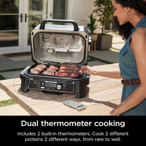 Woman using Woodfire Pro Connect Deluxe XL Backyard Grill and Smoker With Bluetooth App Control 7 in 1 Master Grill outdoors