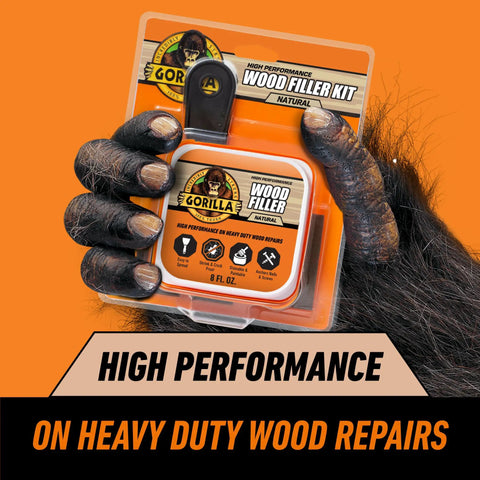 All Purpose Wood Filler Repair Kit With Putty Knife And Sanding Block for DIY Home Projects packaging held by a gorilla hand.