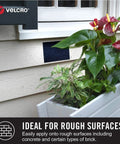 Beefy Extreme Outdoor Heavy Duty Tape With Stick On Adhesive, 10 Ft By 1 In, attached to siding near a window and plants