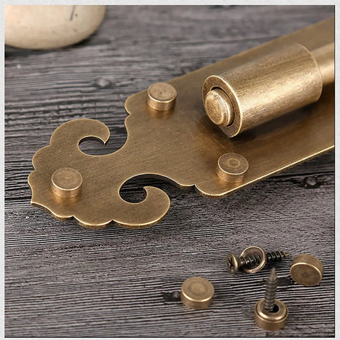 Tough As Nails Heavy Duty Solid Brass Slide Door Bolt Lock With Concealed Screw Surface Mount Hardware, close-up view with screws.