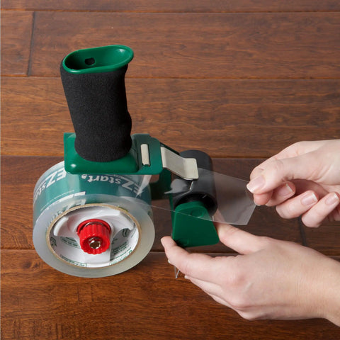 Person using EZ Start Clear Packing Tape Refills For Shipping Moving And Storage 6 Rolls 1.88 Inch By 55 Yards Quiet Easy Start Tape
