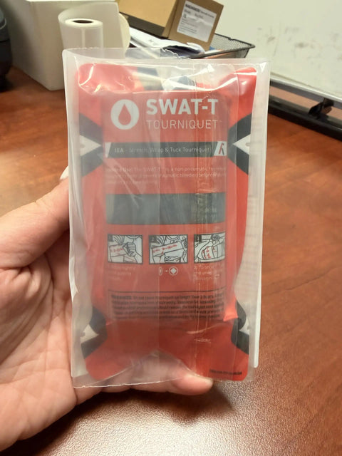 SWAT-T tourniquet in package for quick massive hemorrhage control with stretch wrap and tuck system for emergency use.