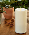 Outdoor Flameless Candle With Remote, Moving Flame Realistic LED Pillar Light on wooden table with plants, 3.25x7 inch