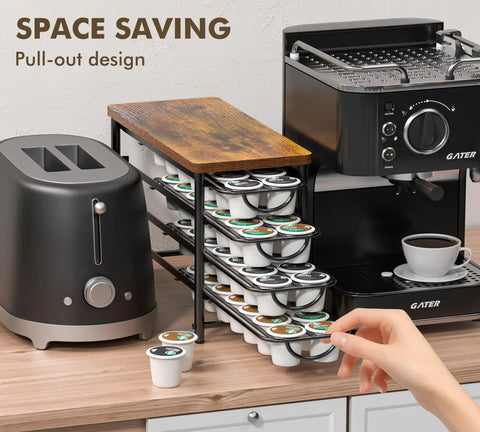 Universal Coffee Pod Holder With Two Multifunctional Storage Drawers For Tea Bags And K Cup Pods Nespresso Dolce Gusto CBTL Verismo Holds Up To 60 Pods In A Retro Brushed Bronze Finish shown with kitchen appliances.