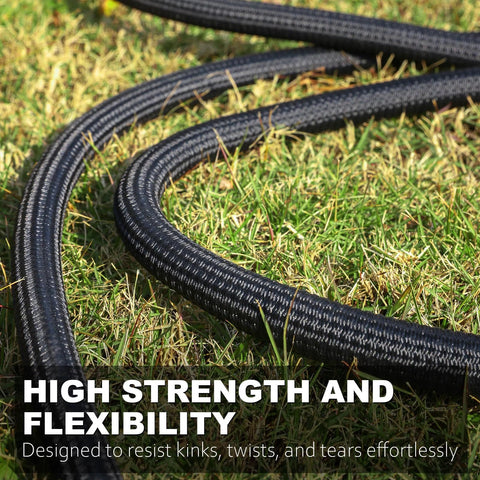 Close-up of black braided garden hose coiled on grass.