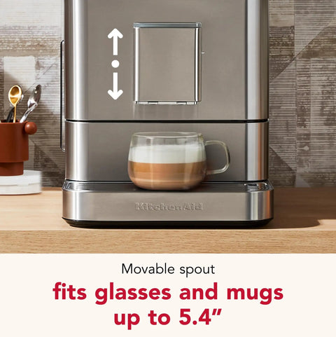 Premium Stainless Steel Fully Automatic Espresso Maker With 15 Signature Drink Recipes Removable Bean Hopper And Easy Touch Controls For Hella Smooth Morning Cup Of Joe with coffee cup under movable spout.