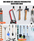 Garage wall with assorted tools hanging on black hooks. Includes saw, hammer, shovels, perfect for tool organization.