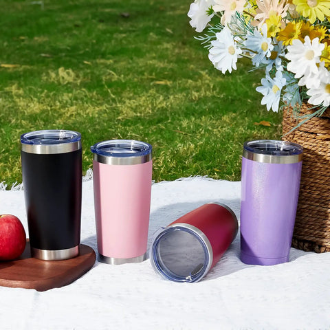 Eight Tough As Nails Twenty Ounce Double Wall Insulated Stainless Steel Tumblers With Secure Lids And Straws That Keep Your Sippin Frosty Or Steaming Hot All Day Long In Sleek Black Finish showcased on a picnic blanket.