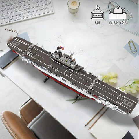 USS Enterprise Aircraft Battleship Building Set With 1883 Pieces 30 Inch Long Model displayed on a desk with accessories