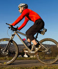 Cyclist on mountain bike with Front Fork Mounted Water Bottle Cage And Cargo Rack For Bikes - Durable Bike Front Rack