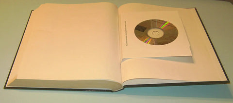 Open book showing a CD in Hands On PLC Mastery A Practical Pro Guide To Programmable Logic Controllers For Industrial Automation Program Analysis And Development Techniques Second Edition.