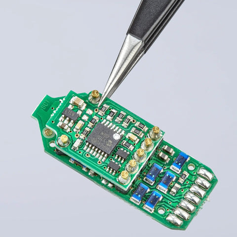 ESD Safe Straight Tip Tweezers, 5-1/4 Inch Stainless Steel, Black Finish, handling components on a green PCB board.