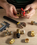 Two Piece Brass Pipe Fitting Three Quarter Inch NPT Hex Nipple Male Pipe Adapter Straight Connector on workbench