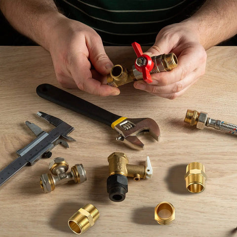 Two Piece Brass Pipe Fitting Three Quarter Inch NPT Hex Nipple Male Pipe Adapter Straight Connector on workbench