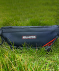 Waterproof Handlebar Tool Bag Made With PVC Tarpaulin For Dirt Bikes That Fits Sur Ron Segway Talaria Off Road Rides And Keeps Your Essentials Dry In Wet Weather Ready For Any Trail Or Wet Conditions. black PVC tarpaulin handlebar bag shown on grass, side view