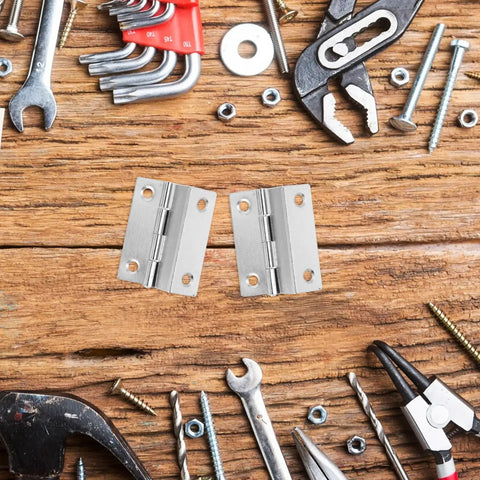 10 Piece Folding Iron Cabinet Hinges With Screws Set and tools on wooden surface