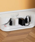 White Cable Management Box for Power Strips up to 10.5 Inches, floor outlet hideaway, cords neatly organized in living room.
