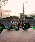 Kids sitting with Green Machine 20 Inch Drift Trike for Kids 8 and Up with Dual Stick Steering, Adjustable Seat, Durable Steel Frame.