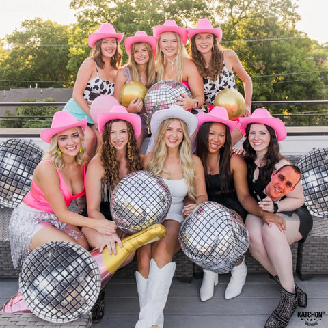 Group with pink hats holding Showstopping 22 Inch Silver Disco Balloons Pack of 6 4D Sphere Balloons for Disco Party Decorations Retro 70s Theme Birthday Anniversary Decor and Photo Backdrops for Lit Party Vibes