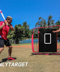 Backstop 4Ft By 6Ft Batting Cage Target Backdrop With Strike Zone in a field setting with players