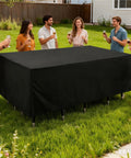 People enjoying a backyard gathering with a Built To Last Heavy Duty Outdoor Table Cover With UV Protection and Waterproof Weatherproof Shield 90.55 Inch Size.