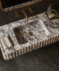 Calacatta Viola Marble Fluted Sink, Hand-Carved Rectangular Bathroom Vanity Basin with textured sides and brushed gold faucet.