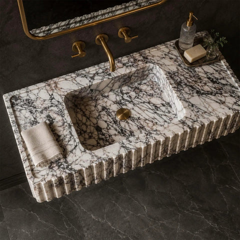 Calacatta Viola Marble Fluted Sink, Hand-Carved Rectangular Bathroom Vanity Basin with textured sides and brushed gold faucet.