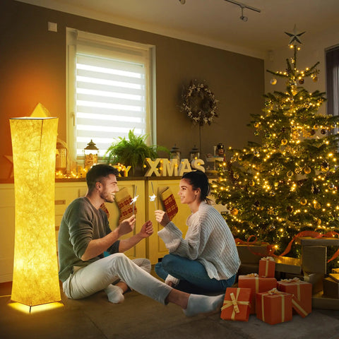 Tall Dimmable Floor Lamp With 52 Inch Frame casting warm light, beside a couple celebrating near a decorated Christmas tree.