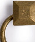 Close-up of solid brass peg and ring pull with square mount holder, ideal for architectural interior design and furniture customization.