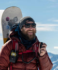 Man using Push To Talk Handheld And Wearable Speaker Microphone Set For GMRS Radios, snowy mountains in background
